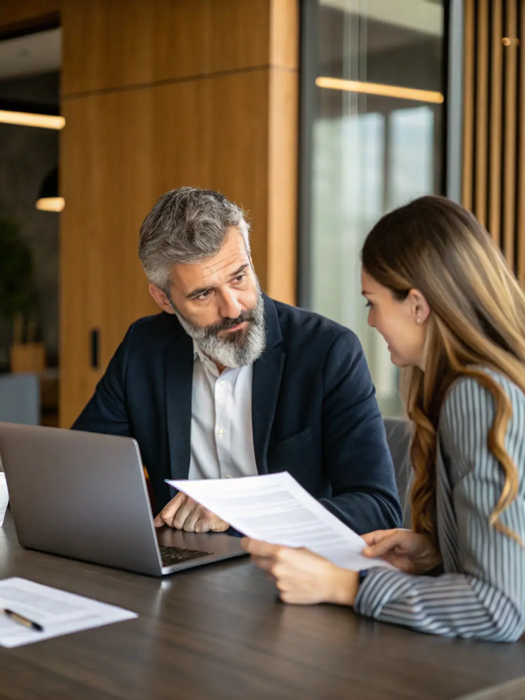 An image of a confident business leader engaging in a coaching session with a professional coach in a modern office setting.